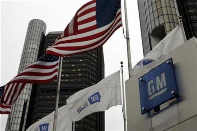 U.S. flags flutter in the wind in front of the General Motors Corp headquarters in Detroit