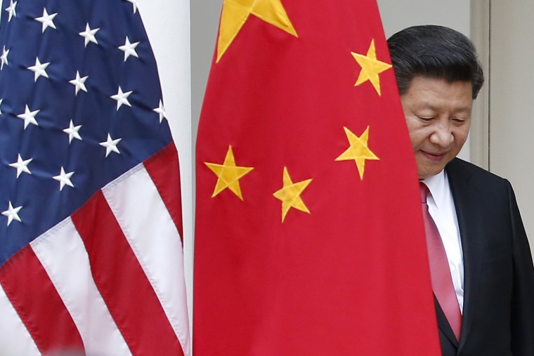 Image: Chinese President Xi Jinping steps out from behind China's flag