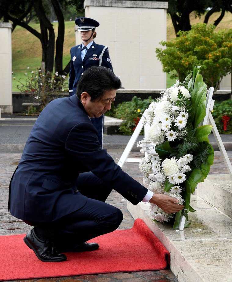 Image: Japanese Prime Minister Shinzo Abe presents a wreath at the National Memorial Cemetery of the Pacific at Punchbowl in Honolulu