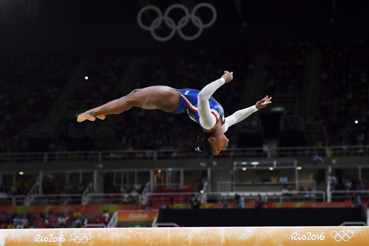 Image: Simone Biles competes in the beam event of the women's individual all-around final