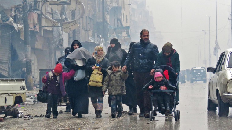 Image: Syrian residents arrive in Aleppo's Fardos neighborhood