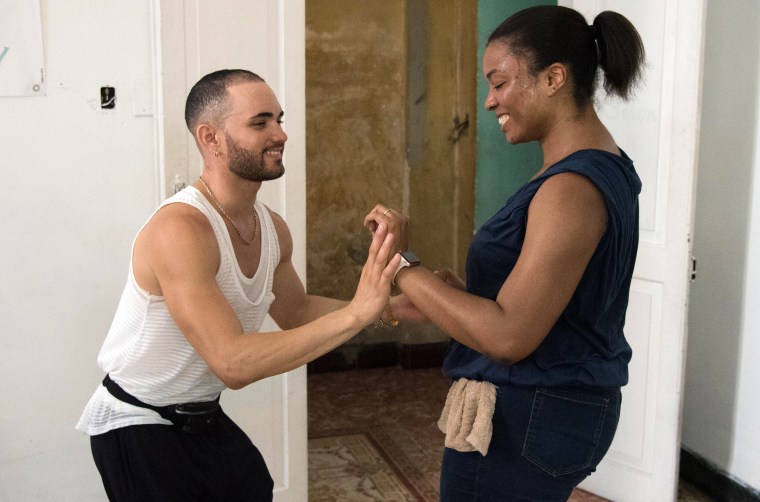 A dance instructor, left, teaches an American visitor salsa steps at Pasion Caribeña, a dance school based in Habana Vieja.