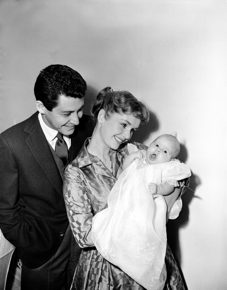 Reynolds and her husband, singer Eddie Fisher, pose with their ten-week-old daughter Carrie Frances for the first family picture, January 2, 1957, in Hollywood, California.