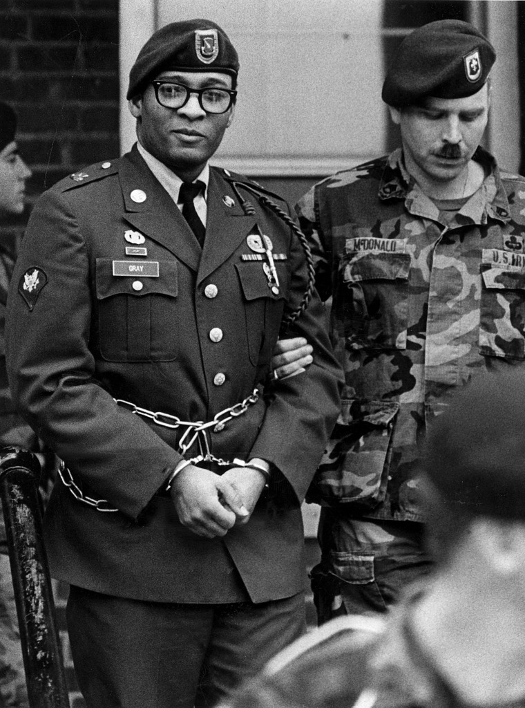 Image: Ronald A. Gray in handcuffs and chains, escorted by military police leaving a Fort Bragg, N.C.