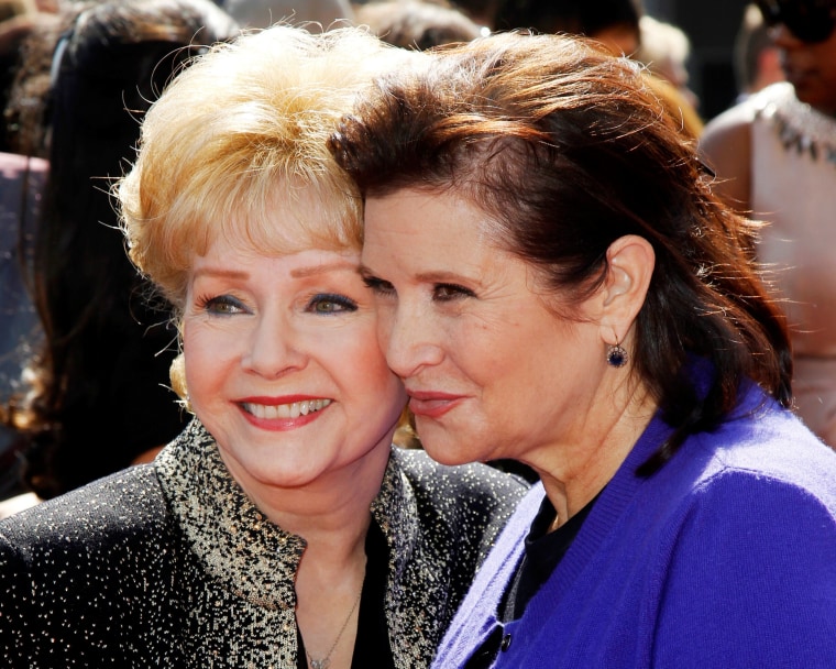 Image: FILE PHOTO: Actress Debbie Reynolds and her daughter Carrie Fisher arrive at the 2011 Primetime Creative Arts Emmy Awards in Los Angeles