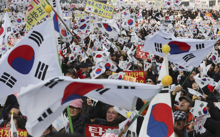 Image: Amid rallies demanding the president's removal, her supporters waved national flags.