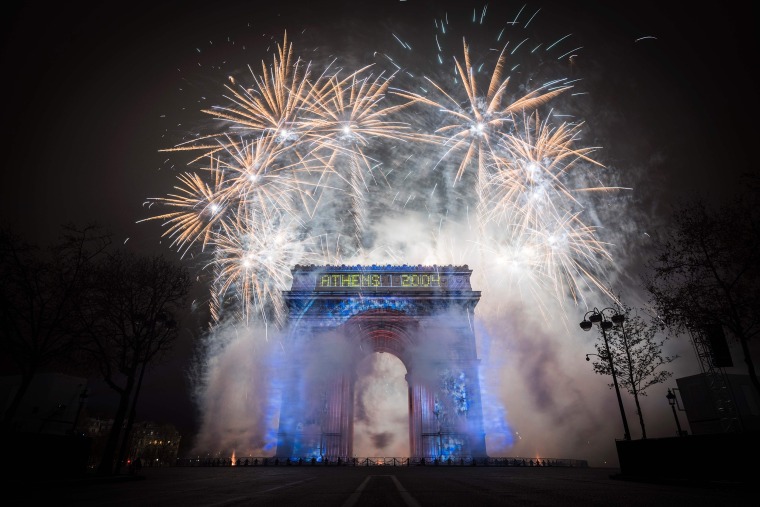 Image: Fireworks explode over the Arc de Triomphe