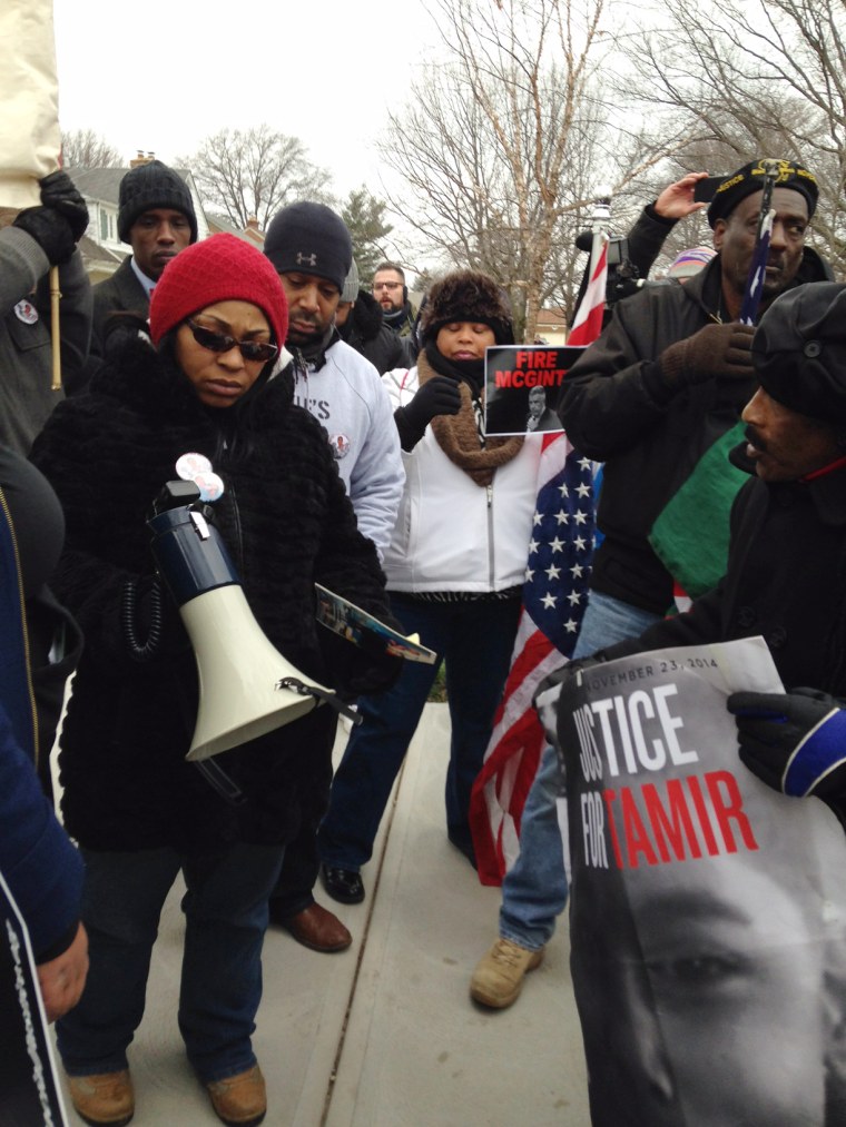 In this photo provided by cleveland.com, a march leader with a megaphone talks to protesters near the home of Cuyahoga County Prosecutor Tim McGinty in Cleveland on Friday, Jan. 1, 2016.