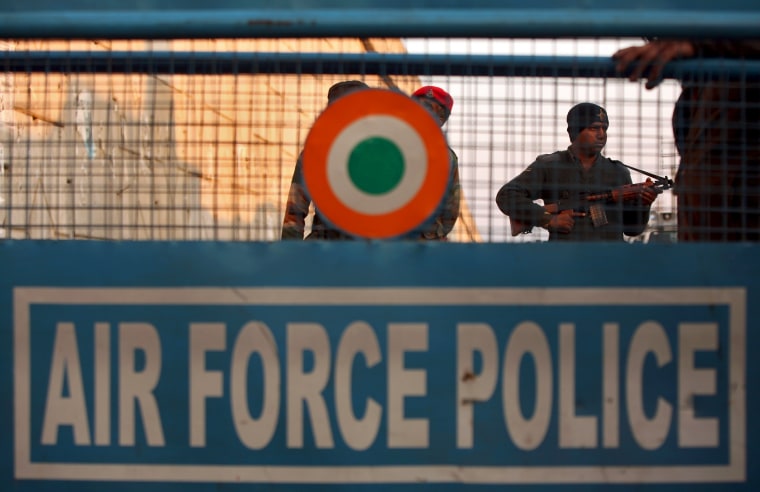 Image: An Indian security personnel stands guard next to a barricade outside IAF base at Pathankot in Punjab