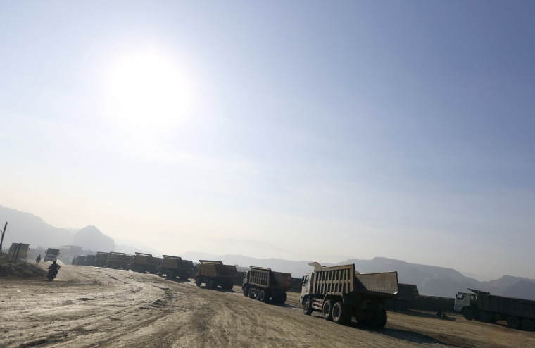Image: Trucks are seen at a jade stone mine dump at a Hpakant jade mine in Kachin state in Myanmar