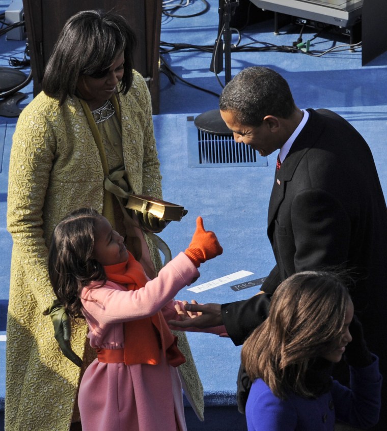 Image of Sasha Obama giving her father, President Obama, a thumbs up after his 2009 inauguration speech.