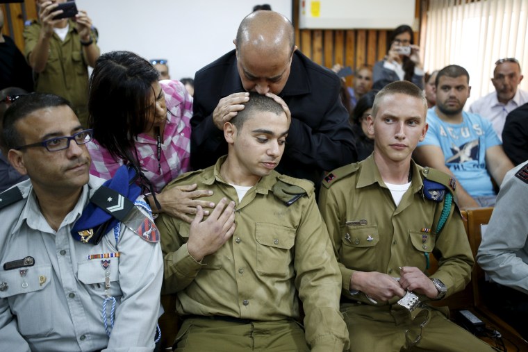 Image: The father of Elor Azaria kisses his head during an earlier hearing.