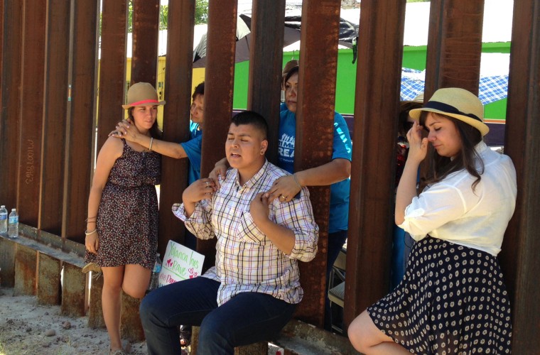 Evelyn Rivera, left, Carlos Padilla, front center, and Renata Teodoro, right, reunite with their mothers on opposite sides of the border wall that divides Nogales, Arizona from Nogales, Mexico, on June 11, 2013. The youth, who were born in Mexico and brought to the U.S. as children, traveled from Seattle, Miami and Boston to meet at the border fence with their mothers who they had not seen in years. The four are "dreamers," youth whose families entered the country without authorization when they were children.