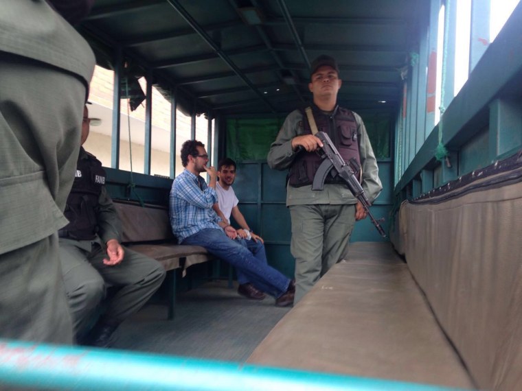 Venezuelan activist Francisco Marquez and colleague Gabriel San Miguel, sit in the back of a truck shortly after being stopped at a security checkpoint by the Venezuelan National Guard