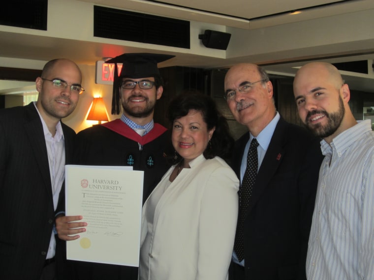 Venezuelan activist and lawyer Francisco Marquez, surrounded by his family, holds his diploma after graduating from Harvard's John F. Kennedy School of Government