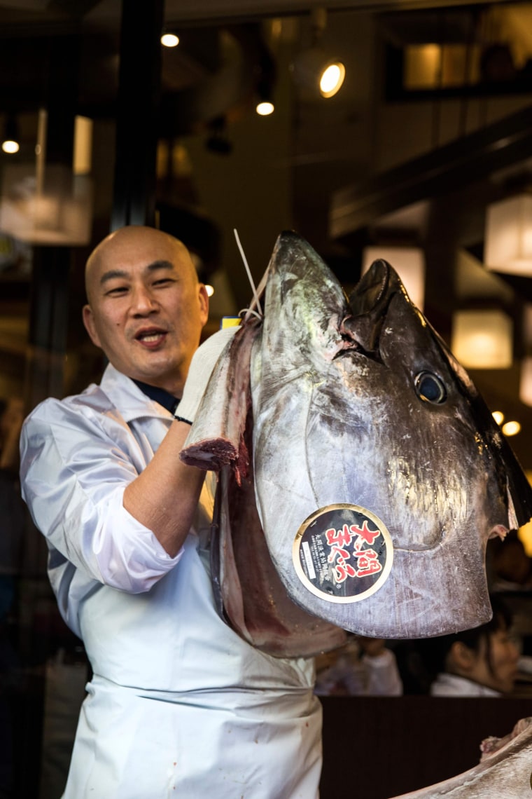 Image: Restaurant worker with head of bluefin tuna