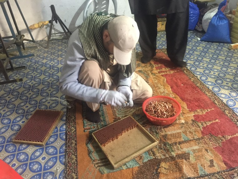 Image: A worker counts and packs a box of the popular "NATO Power" rounds