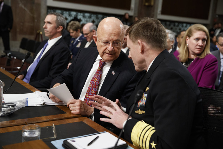 Image: Director of National Intelligence James Clapper, center, talks with National Security Agency and Cyber Command chief Adm. Michael Rogers