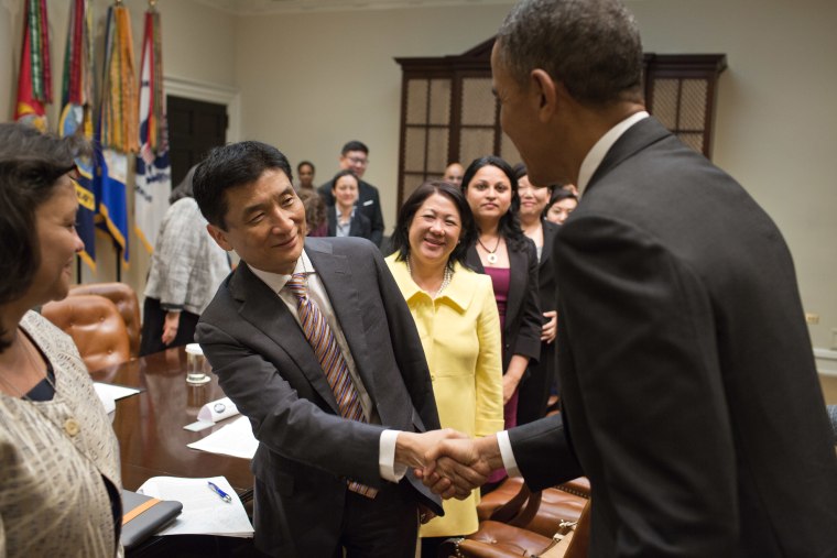 President Barack Obama shakes hands with Bill Imada in a meeting with a group of Asian American and Pacific Islander (AAPI) national leaders to discuss immigration reform, in the Roosevelt Room of the White House, May 8, 2013.