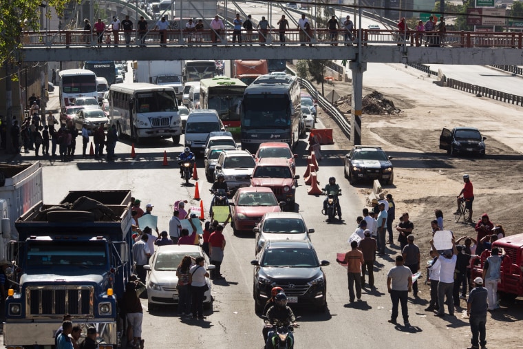 Image: People block a highway leaving Mexico City as a protest to an increase in gas prices on Jan. 4.