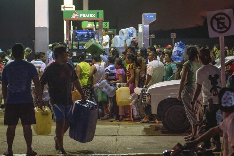 Image: Residents steal gasoline and diesel from a gas station following protests against an increase in fuel prices in Allende, southern Veracuz State, Mexico, late on Jan. 3.