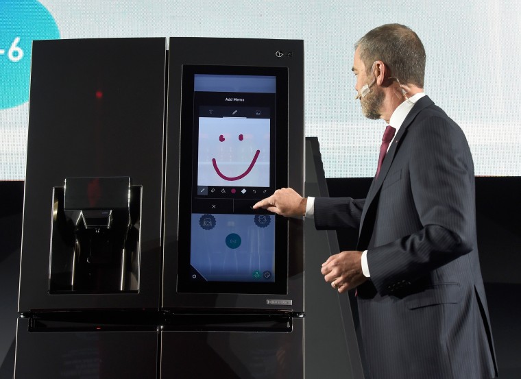 Image: An LG employee  demonstrates the LG Smart InstaView Door-in-Door refrigerato