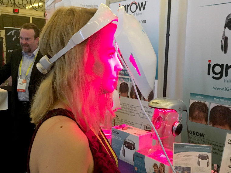 Image: NBC News technology reporter Alyssa Newcomb tries on the iDerma from Apira Science.