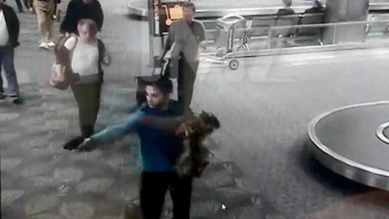 Image: A screengrab of surveillance footage shows Esteban Santiago as he fires his first shots in the baggage claim area of Florida's Ft. Lauderdale International Airport, Jan. 6, 2017.