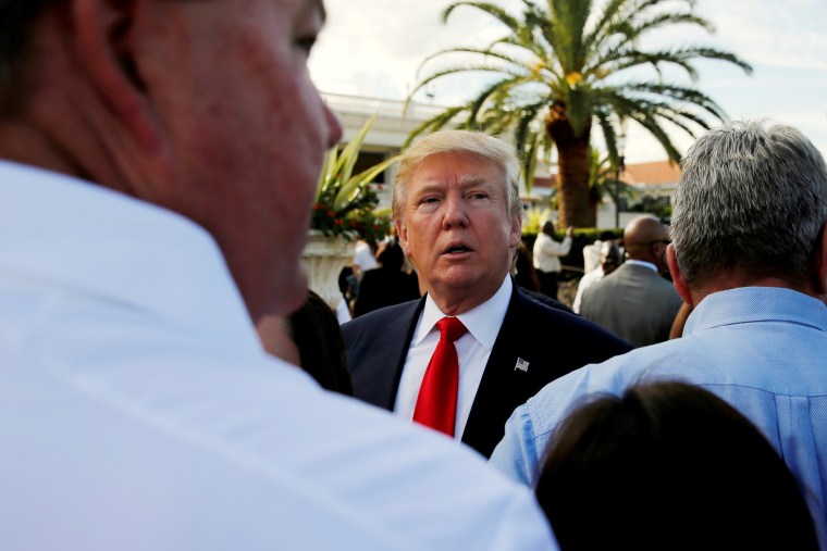 Image: Donald Trump listens to questions from reporters after a campaign event with his employees at his Trump National Doral golf club in Miami, Florida, Oct. 25, 2016.