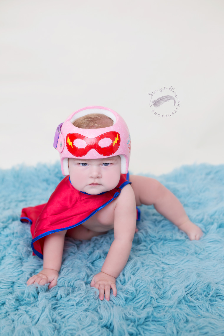 Kaitlyn Smith says when she learned her daughter, Juniper, needed a helmet, she found herself captivated by Strawn's designs. "The design we chose was a super hero theme and just kind of spilled out of my brain," said Smith. "The two quotes were chosen because they were funny, and represented the essence of Juniper."