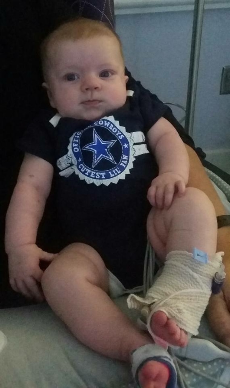 Girl with heart defect wearing Dallas Cowboys onesie