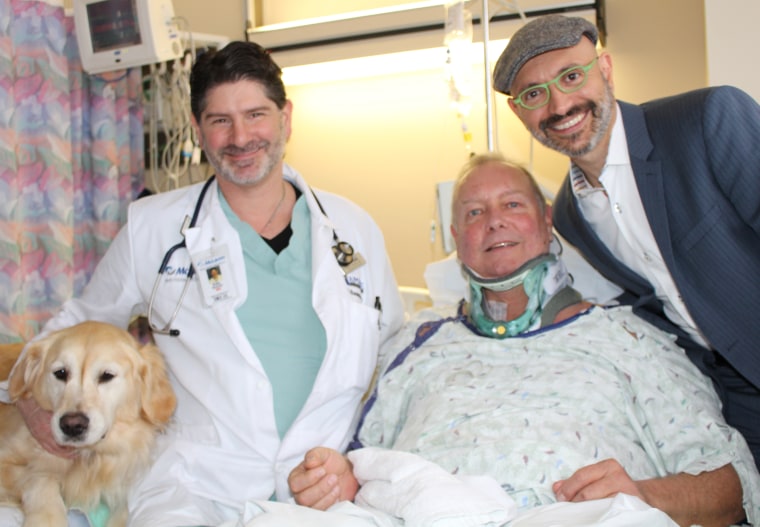 Bob with the doctors who treated him and his dog, Kelsey. 