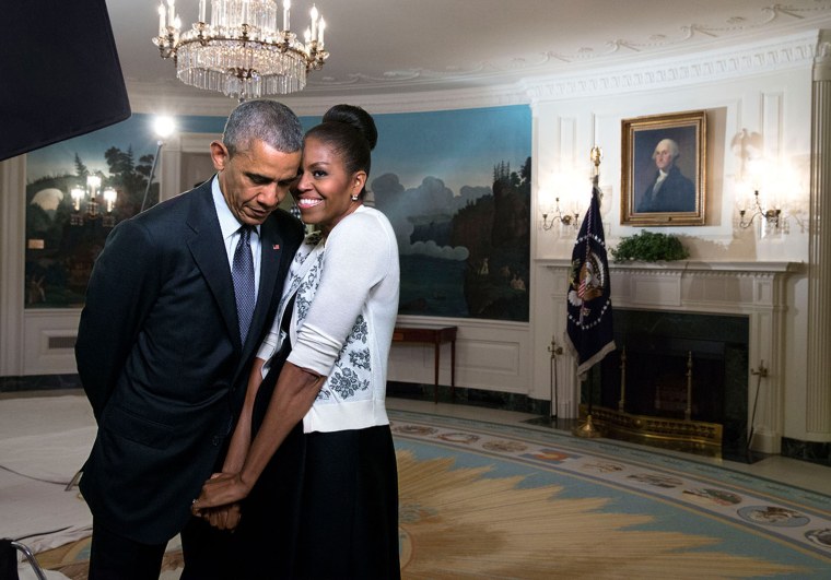 First Lady Michelle Obama snuggles against President Barack Obama before a videotaping for the 2015 World Expo, in the Diplomatic Reception Room of the White House, March 27, 2015.