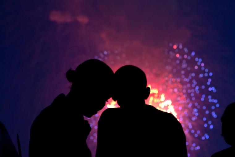 photo of President Obama and the first lady watching fireworks from the White House, July 4, 2010.