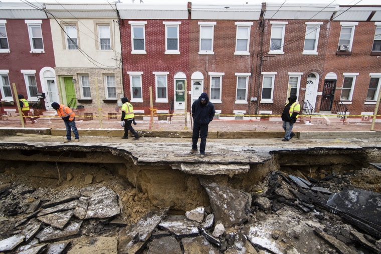 Image: Workers inspect a sinkhole in Philadelphia on Jan. 9.