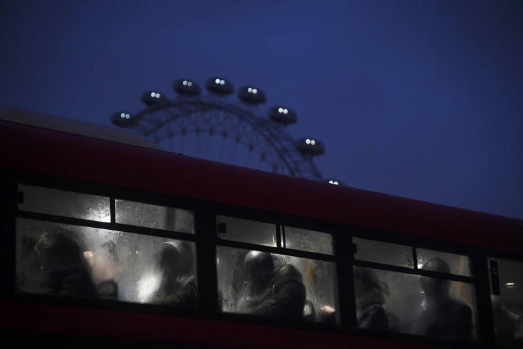 Image: Commuters ride a bus over Westminster Bridge past the London Eye during a strike on the Underground by members of two unions in protest of ticket office closures and reduced staffing levels on Jan. 9.