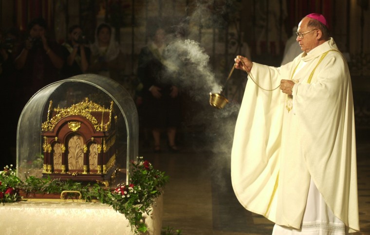 Image: Archbishop Patrick Flores incenses the reliquary of St. Therese on Dec. 3, 1999 at the Basilica of the Nation Shrine of the Little Flower in San Antonio, Texas.