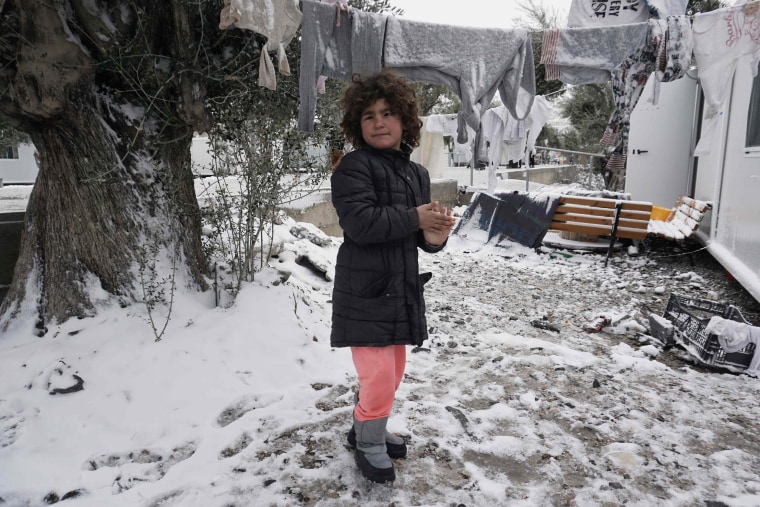 Image: A girl plays in the snow at the Kara Tepe camp on Lesbos, Greece.