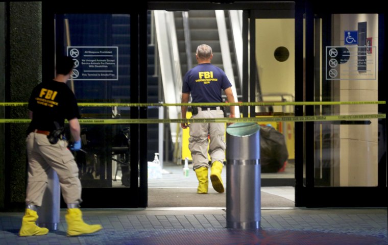 Image: Investigators continue their work in Terminal 2 at Fort Lauderdale International Airport on Jan. 7, the day after a shooting in the baggage area.