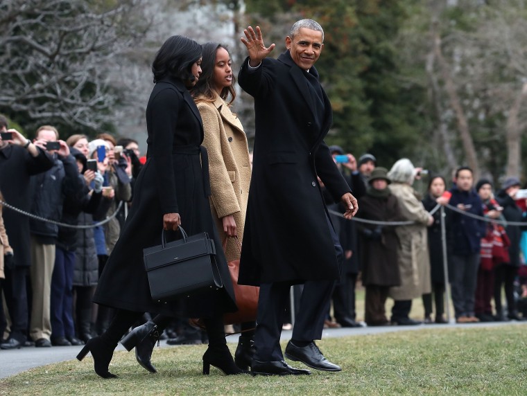Image: President Obama waves as he walks with first lady Michelle Obama and daughter Malia toward Marine One while departing from the White House on Jan. 10.