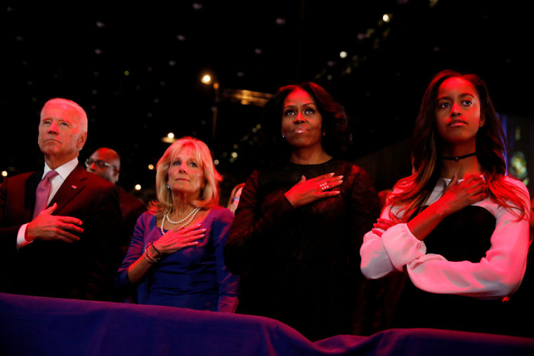 Image: Vice President Joe Biden (L-R), his wife Jill Biden, first lady Michelle Obama and her daughter Malia Obama stand for the national anthem before President Obama delivers his farewell address in Chicago, Illinois on Jan. 10.