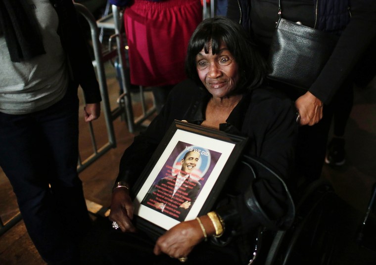 Image: A woman holds a photo of President Obama before he gives his farewell address in Chicago, Illinois on Jan. 10.