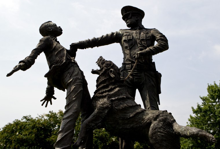 Image: A young protester confronted by a police officer and a snarling police dog is depicted in a sculpture in Kelly Ingram Park in Birmingham, Ala. on Aug. 6, 2013.