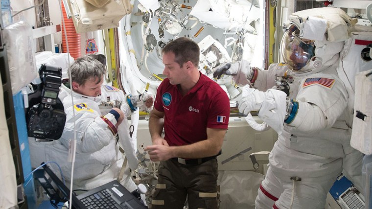 Image: Astronaut Thomas Pesquet (center) assists spacewalkers Peggy Whitson (left) and Shane Kimbrough in the U.S. Quest airlock on Jan. 6, 2017.