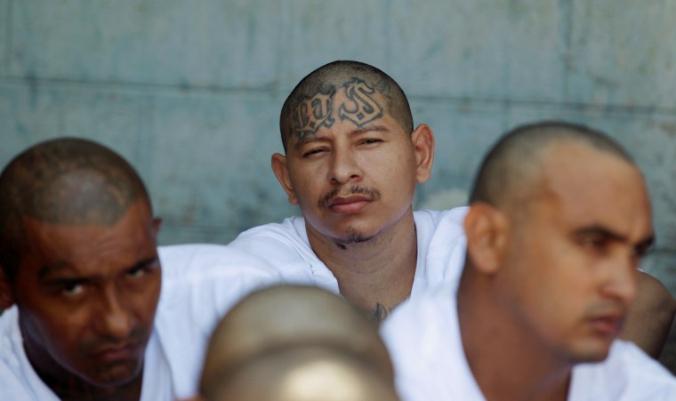 Mara Salvatrucha (MS-13) gang members wait to be escorted upon their arrival at the maximum security jail in Zacatecoluca