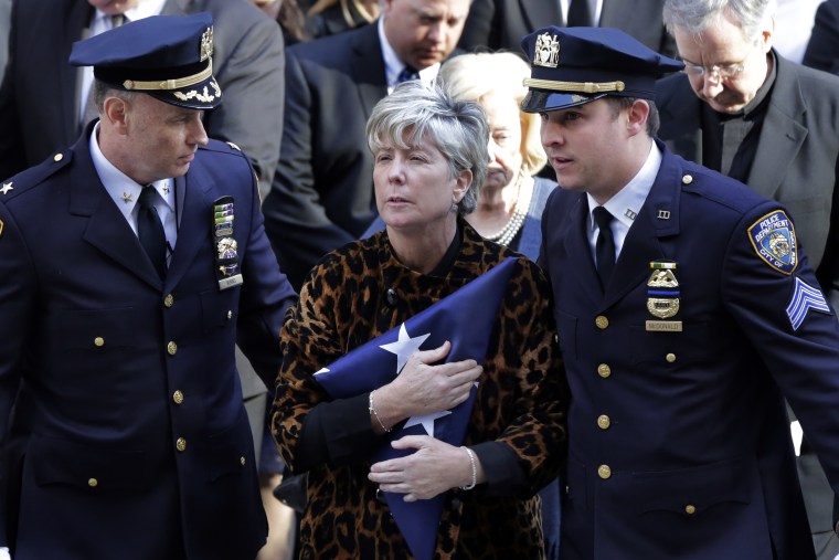 Image: Patricia McDonald, center, and Sgt. Conor McDonald, right, the widow and son of Detective Steven McDonald, leave his funeral at St. Patrick's Cathedral on Jan. 13 in New York, New York.