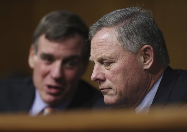 Image: Senate Intelligence Chairman Sen. Richard Burr, right, and committee Vice Chairman Sen. Mark Warner confer on Capitol Hill in Washington, D.C. on Jan. 12 during the committee's confirmation hearing for CIA Director-designate Rep. Michael Pompeo.