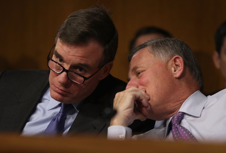 Image: Sen. Mark R. Warner, Vice Chair of the Senate Select Committee on Intelligence, and Sen. Richard Burr, Chairman of the Senate Select Committee on Intelligence, speak together during the Senate Intelligence Committee on Capitol Hill on Jan. 10 in Wa