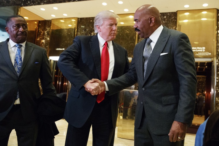 Image: President-elect Donald Trump shakes hands with comedian Steve Harvey in the lobby of Trump Tower in New York on Jan. 13.