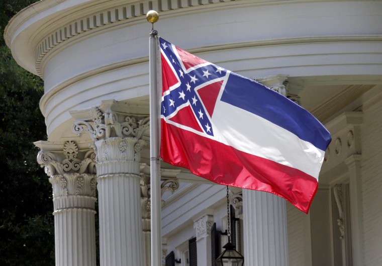 Image: The Mississippi state flag is unfurled against the front of the Governor's Mansion in Jackson, Mississippi, 2015.